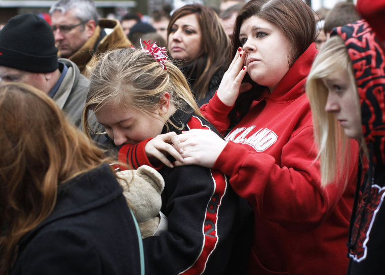 Image: Students and parents gather outside a memorial remembering the victims of the Chardon High school shootings in Chardon